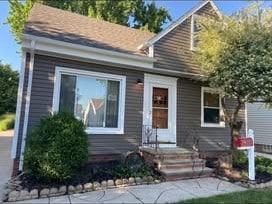 Home with new charcoal-gray vinyl siding and white trim