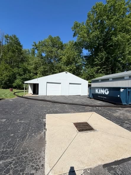 Finished pole barn with metal roof and siding and new concrete apron