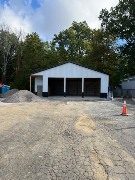 Finished 48 by 40 foot post-frame pole barn with large overhead door openings